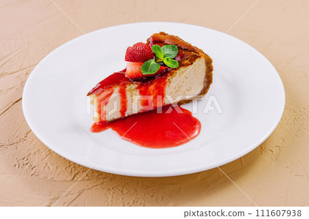 cheesecake with strawberry jam on plate cheesecake with strawberry jam on plate 111607938