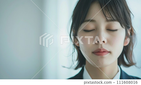 Young business woman relaxing with eyes closed 111608016
