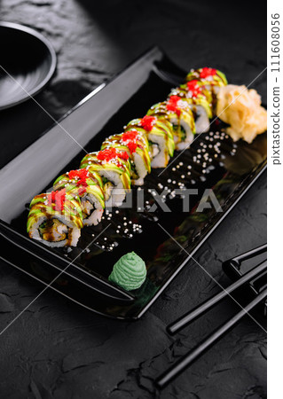 Avocado Sushi roll japanese food on black plate Avocado Sushi roll japanese food on black plate 111608056