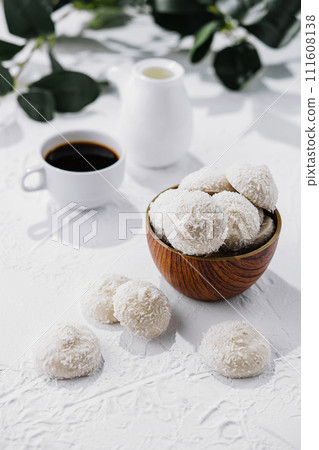 candies in white glaze and coconut flakes 111608138
