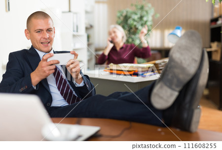 Man office worker using smartphone during break 111608255
