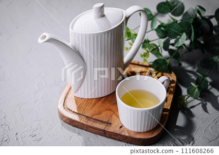 Japanese green tea in white cup and teapot Japanese green tea in white cup and teapot 111608266