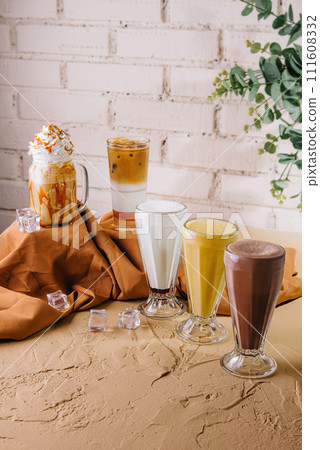 milkshake glasses featuring different flavors 111608332