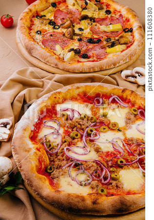 tuna pizza and artichoke pizza with ham 111608380