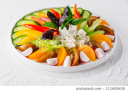 chopped cucumbers, tomatoes, peppers, radishes and feta cheese 111608430