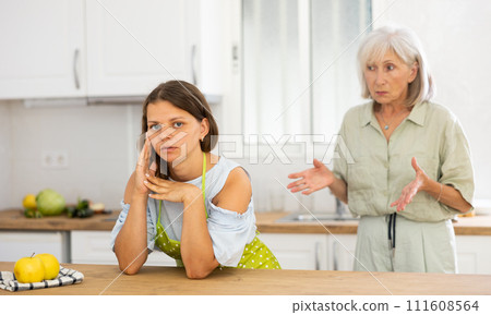 Aggrieved woman having quarrel with her elderly mother 111608564