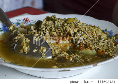 Lontong Kupang, a traditional Indonesian soup made with steamed rice cakes and small mussels. 111608583