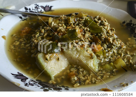 Lontong Kupang, a traditional Indonesian soup made with steamed rice cakes and small mussels. 111608584