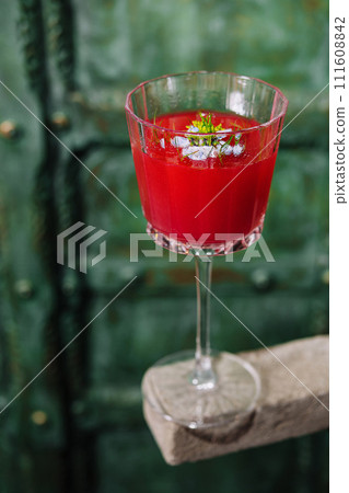 Italian cocktail with flower on gray stone 111608842