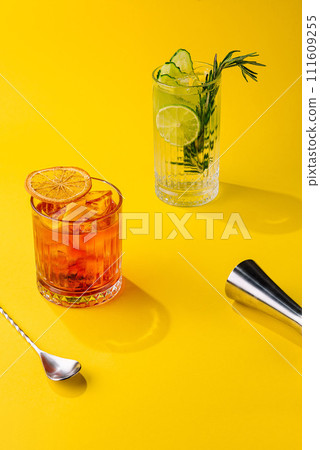 Cocktail Negroni and mojito cocktail on yellow background 111609255