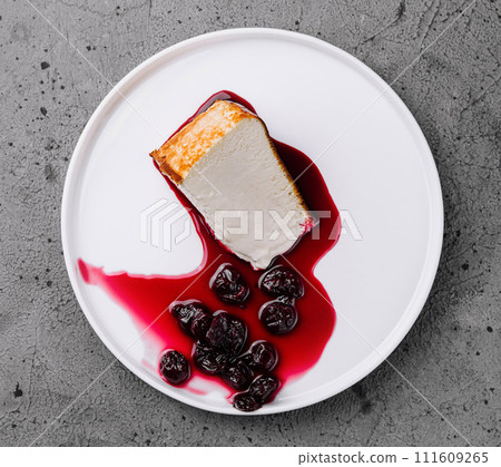 Cheesecake with berry sauce on plate Cheesecake with berry sauce on plate 111609265