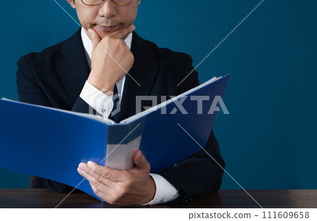 Hand of a businessman checking a file 111609658