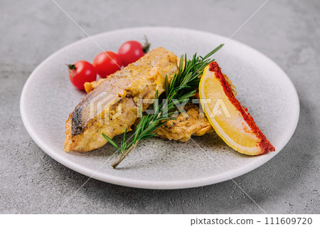 grilled fish steak and vegetables on a plate grilled fish steak and vegetables on a plate 111609720