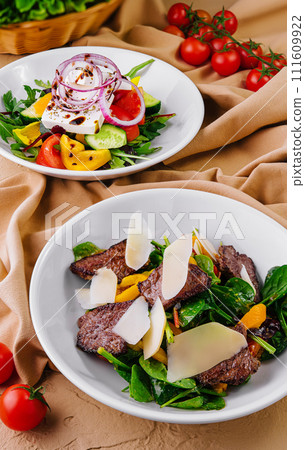 warm salad with meat and vegetable salad with sheep cheese 111609922