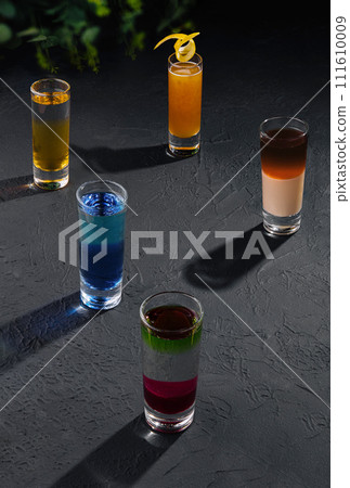 Multicolored shots on dark stone Multicolored shots on dark stone 111610009