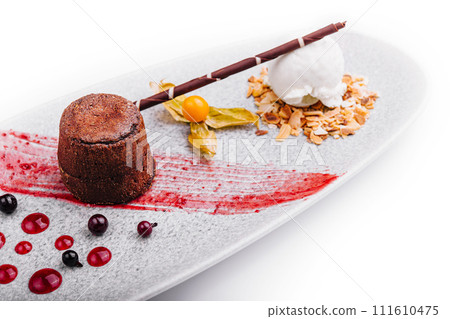 White plate with chocolate fondant cake White plate with chocolate fondant cake 111610475