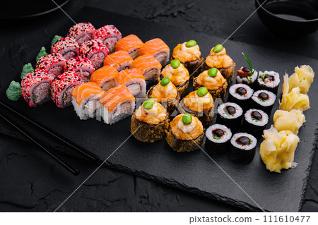 Sushi set on black slate top view Sushi set on black slate top view 111610477