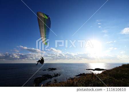 Paraglider with the sun behind 111610610