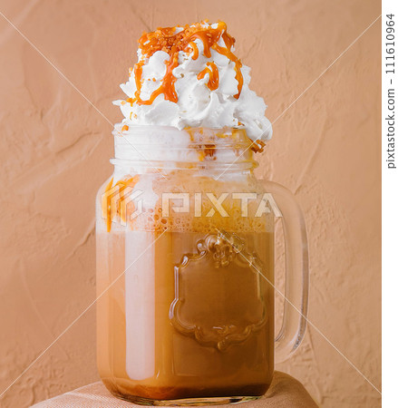 Caramel iced latte with whipped cream 111610964
