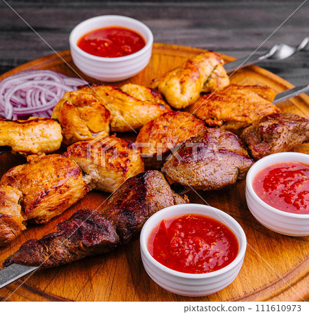Metal skewers with delicious meat and ketchup sauce 111610973