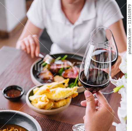 Man and woman drinking red wine in the restaurant Man and woman drinking red wine in the restaurant 111610979