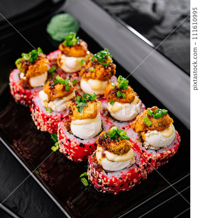 Japanese food. Sushi roll on black plate Japanese food. Sushi roll on black plate 111610995