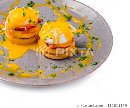 Pancakes with Poached Egg on Plate 111611139