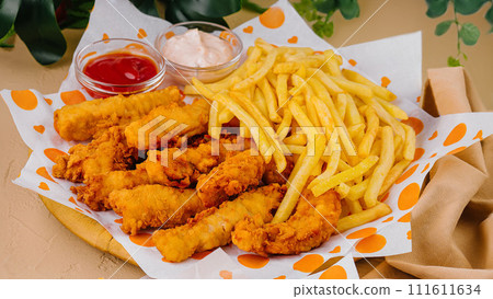 french fries with chicken nuggets and sauces french fries with chicken nuggets and sauces 111611634