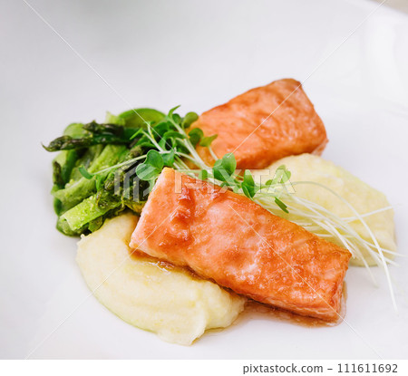 salmon steaks with mashed potatoes on white plate 111611692