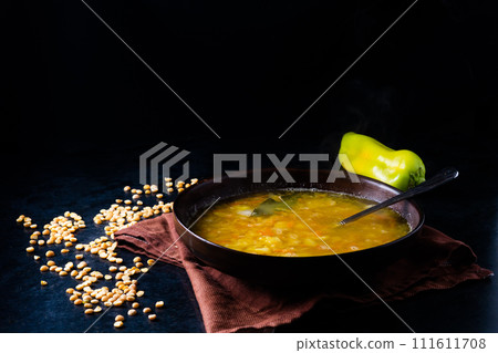 Homemade healthy vegetable soup with some bread and onion 111611708