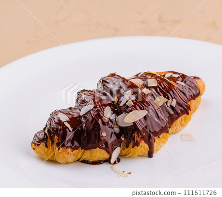 fresh baked croissant with chocolate and almonds fresh baked croissant with chocolate and almonds 111611726