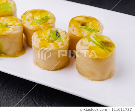 sweet pancake rolls with kiwi 111611727