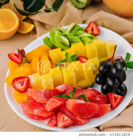 assorted sliced tropical fruits on plate assorted sliced tropical fruits on plate 111611829