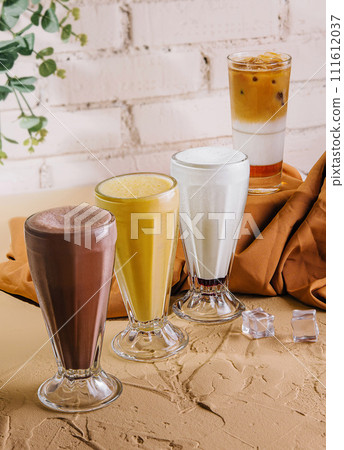 milkshake glasses featuring different flavors 111612037