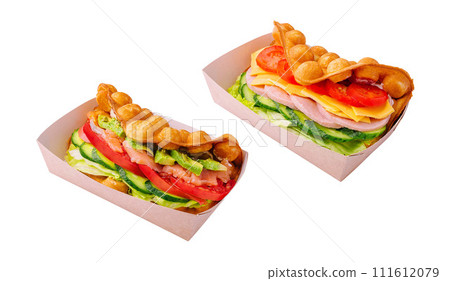 Belgian waffles with salmon, ham, avocado and salad on boxes 111612079