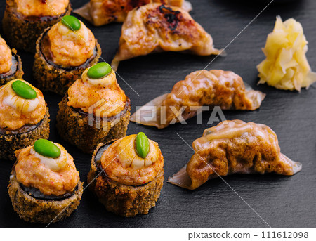 Gyoza or dumplings snack and warm sushi top view 111612098
