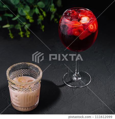 Glasses of cold infused water with fresh orange and strawberry slices and iced coffee Glasses of cold infused water with fresh orange and strawberry slices and iced coffee 111612099