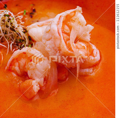 Traditional Thai soup Tom Yam in black bowl 111612155