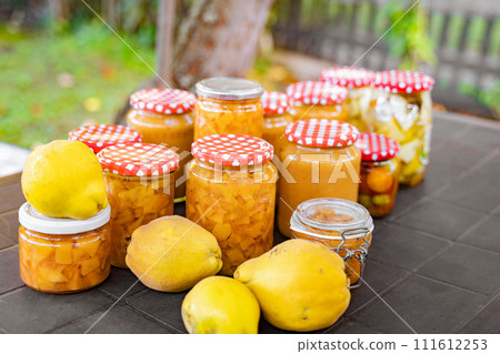 Table displaying jars of jam, lemons, and other natural food ingredients 111612253