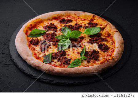 Pizza with minced meat and mozzarella on a stone board 111612272