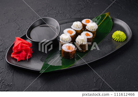 Sushi with Philadelphia Cheese and salmon on Black Asian Plate Sushi with Philadelphia Cheese and salmon on Black Asian Plate 111612466