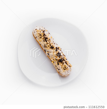 Eclair with cream and chocolate on plate 111612550
