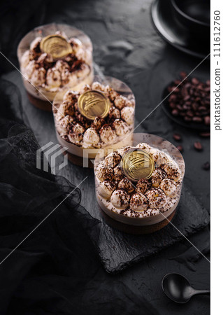 Classic tiramisu dessert in a glass top view Classic tiramisu dessert in a glass top view 111612760