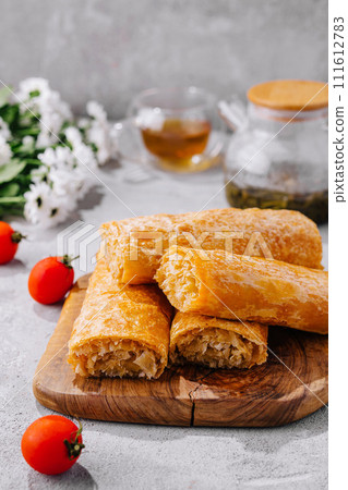 Cooking traditional pies with potatoes on wooden table Cooking traditional pies with potatoes on wooden table 111612783