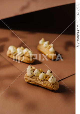 eclairs with whipped cream and hazelnuts eclairs with whipped cream and hazelnuts 111612800