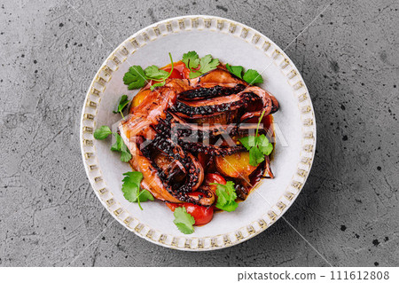 Grilled octopus with vegetables on top view Grilled octopus with vegetables on top view 111612808