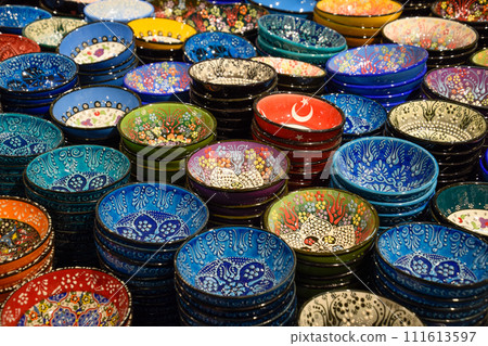 Painted beautiful dishes on the counter. 111613597