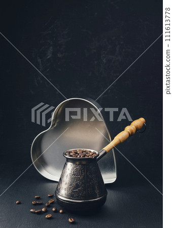 Coffee beans and freshly ground coffee powder on dark wooden background close up. offee with spices. Coffee beans and freshly ground coffee powder on dark wooden background close up. offee with spices. 111613778