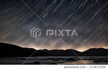 Long exposure photography capturing stars trailing across the cosmos. Streaks of white against a deep 111615209