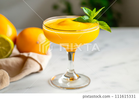 Mango smoothie in a martini glass isolated on white background 111615331